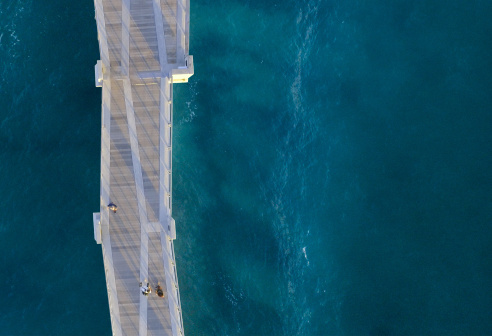 Ein Pier über einem Meer, auf dem Personen entlang gehen. Das Pier repräsentiert visionpier, den Marktplatz für Bildverarbeitungslösungen.